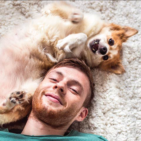Man sitting at a table petting a cat